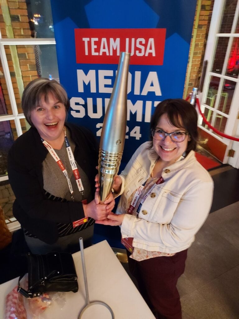 Olympian-and-paralymic-24-torch - Official Libsyn Blog Jill and Alison holding the paris 24 Olympian torch with big smiles