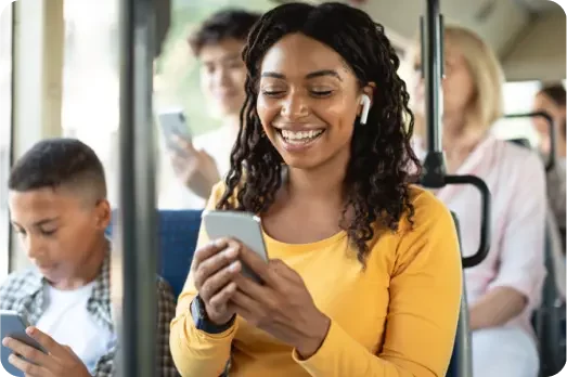 Woman in yellow shirt podcasting on public transportation.