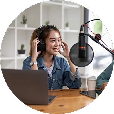 Woman with headphones and microphone while podcasting